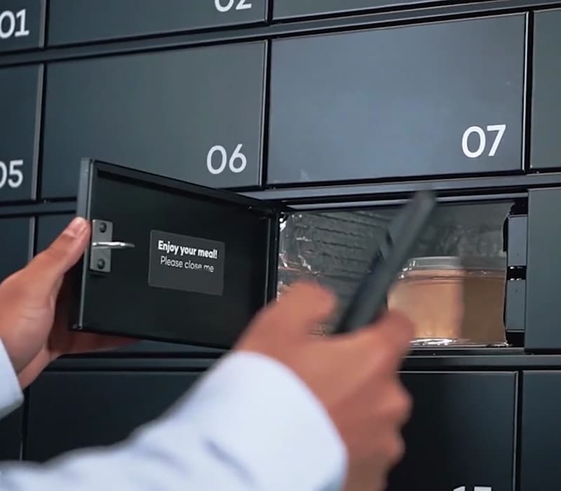 Photo of a man removing a meal from an interactive food locker