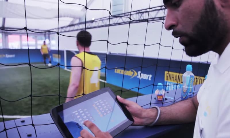 Photo of a pitch-side official updating scores using their tablet app