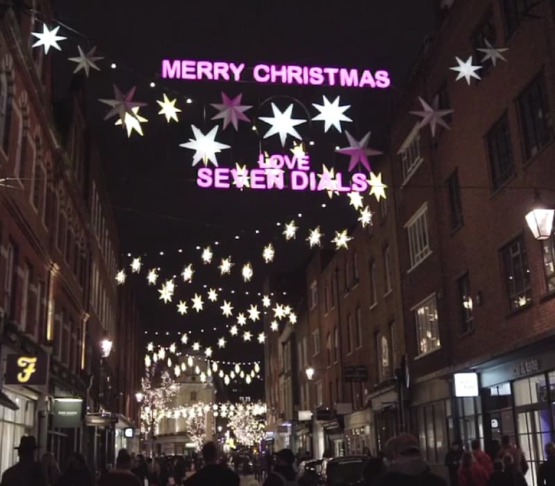 A photo of the Seven Dials Christmas lights installation, showing the words Merry Christmas surrounded by a twinkling light display.
